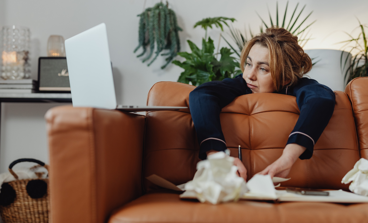 Woman on virtual therapy session holding back