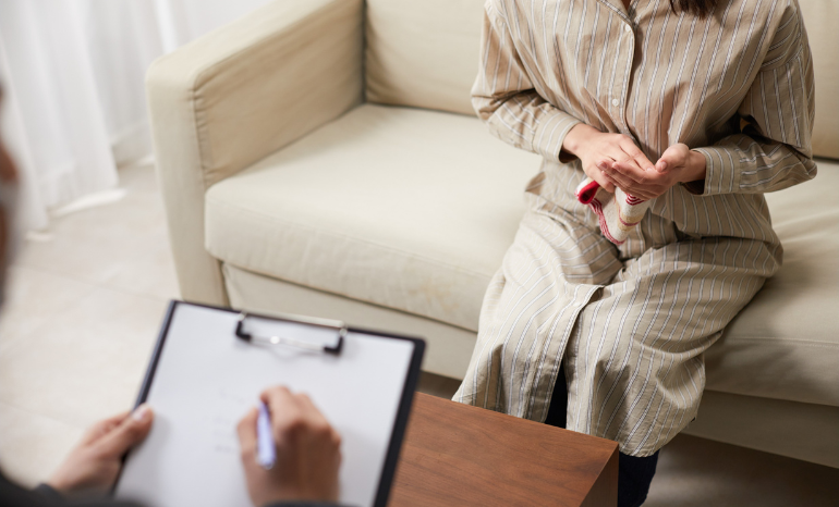 Woman in counseling holding back